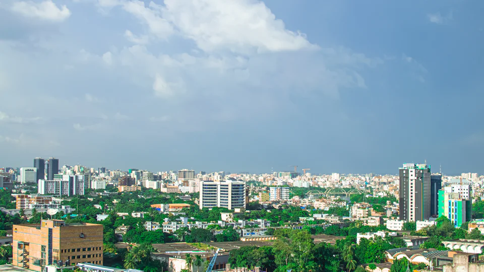 Apartment buildings among mature trees in central Dhaka