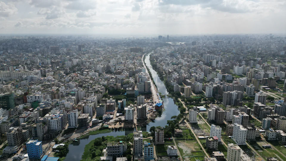 A waterway running through dense low-rise Dhaka, seen from the air