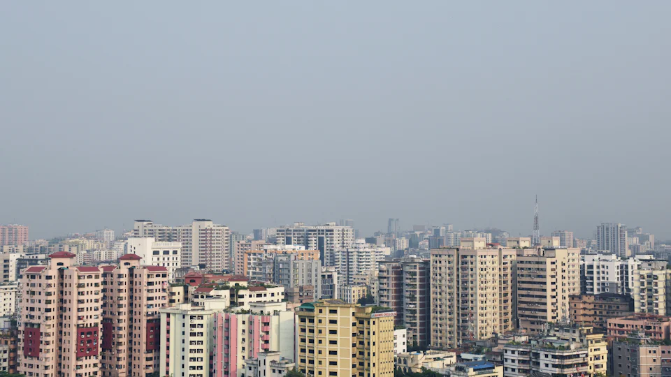Dense apartment blocks across Dhaka, seen from above the rooftops
