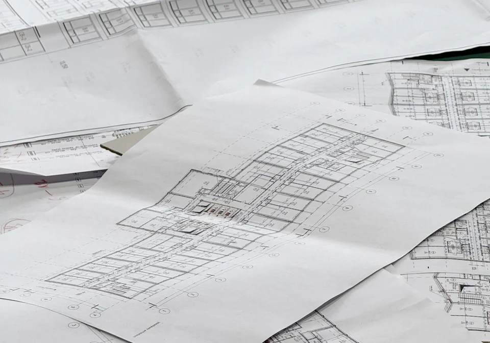 Architectural floor plans spread out for review