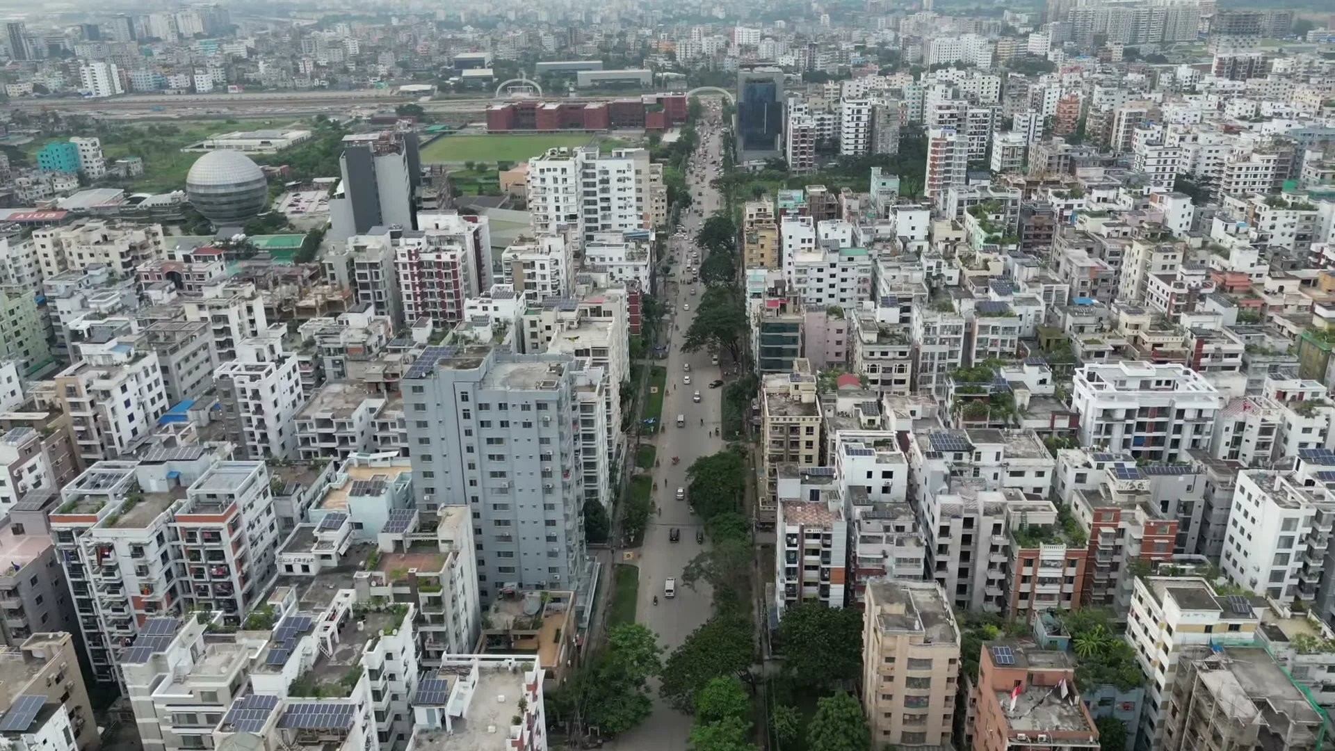 Aerial view over the Bashundhara Residential Area grid, block roads lined with apartment buildings